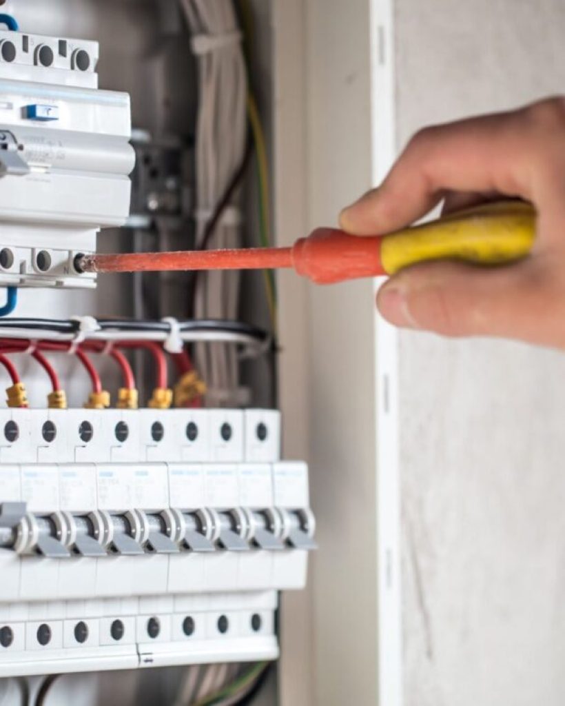 An electrician in Montrose upgrading a switchboard in Melbourne Image shows a man with a screwdriver on a circuit breaker